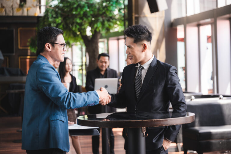 Young business people shaking hands in the office, Finishing successful meeting, handshake of business people deal business